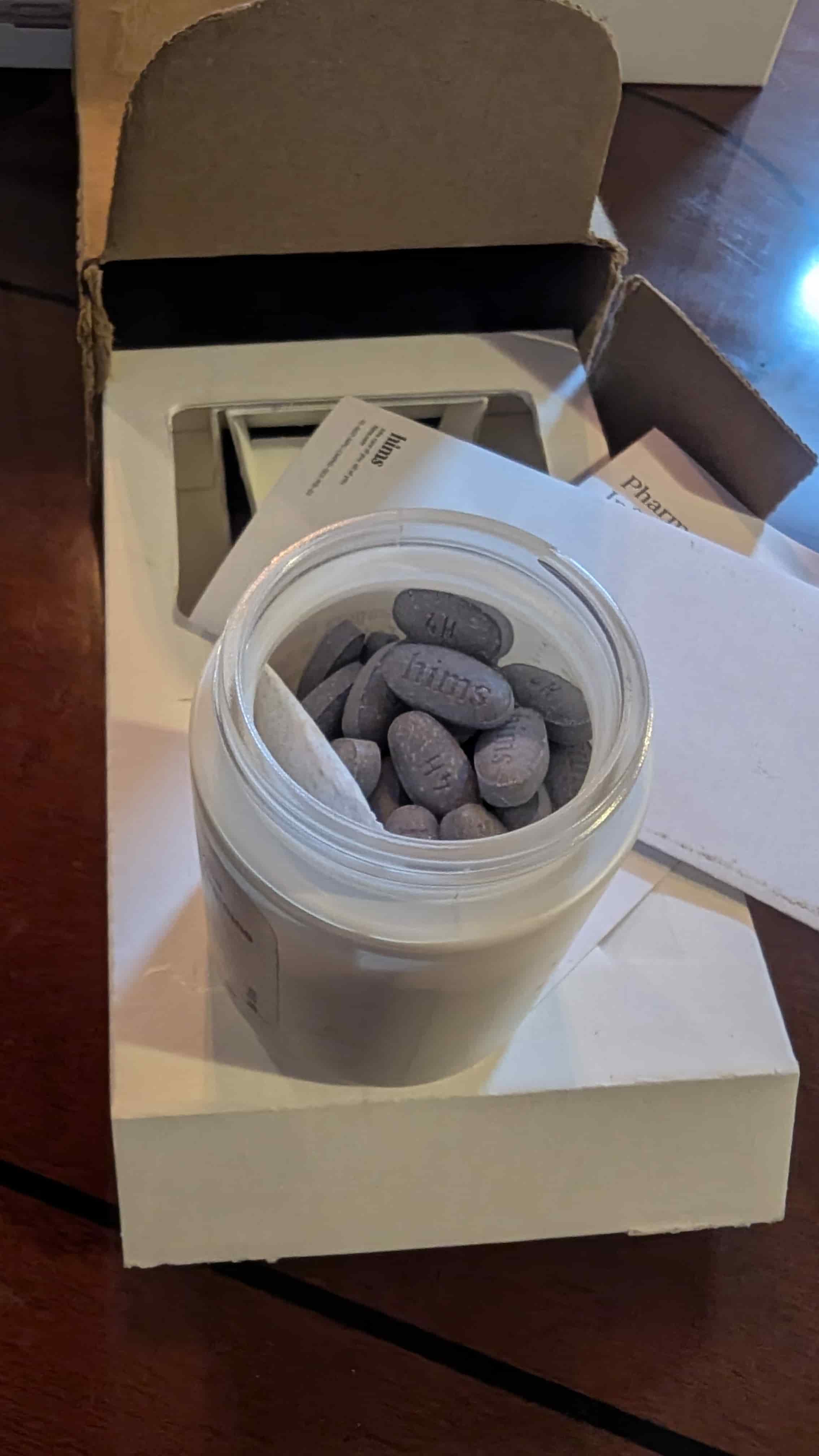 Prescription bottle open with visible pills